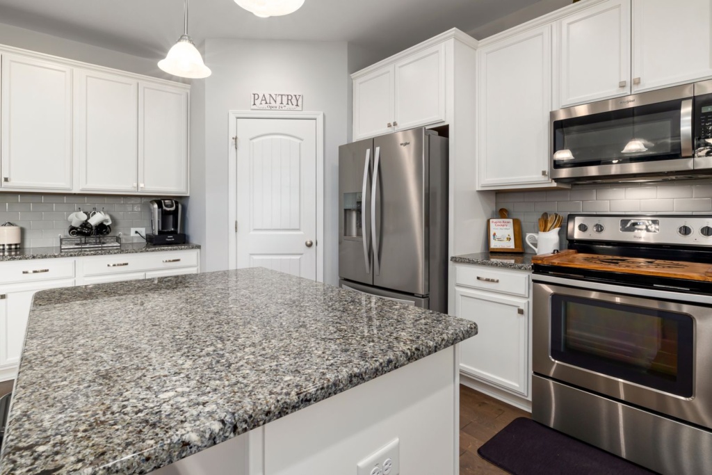 Spotless vacation rental kitchen with granite countertops, stainless steel appliances and a coffee maker set out, ready for the next guests in Port St. Lucie